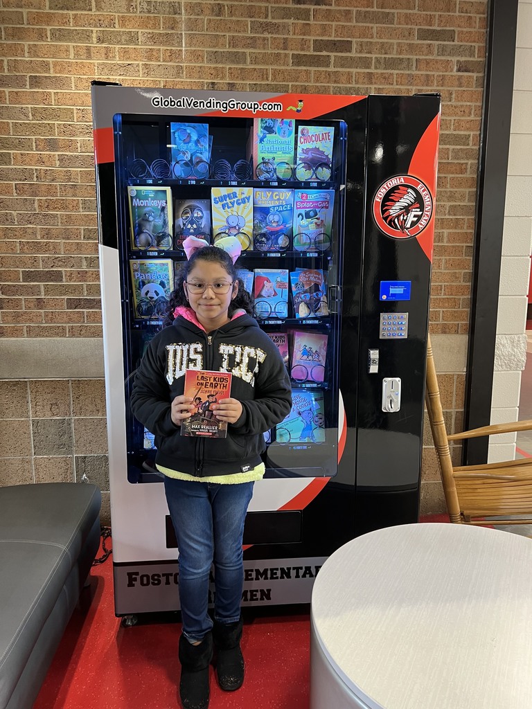 student buying book at book vending machine
